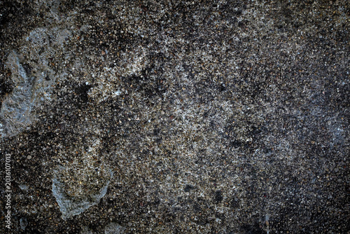 Dark grunge concrete texture background with small pebbles and rough stones