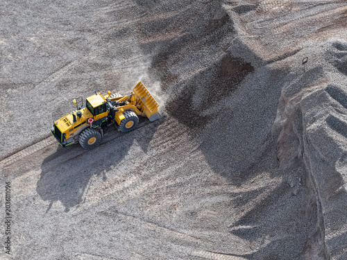 Tableau sur toile Front loader moving gravel in an industrial mining quarry area