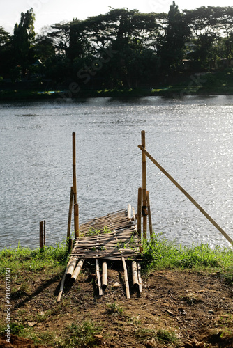 Canvas-taulu small rickety pier on the riverbank made of bamboo