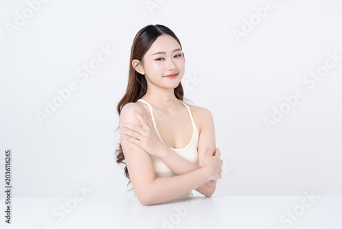 Beautiful young Asian woman healthy skin body and face with hand touching body so gentle on white background. for advertising about skincare, cosmetics, beauty makeup concepts.