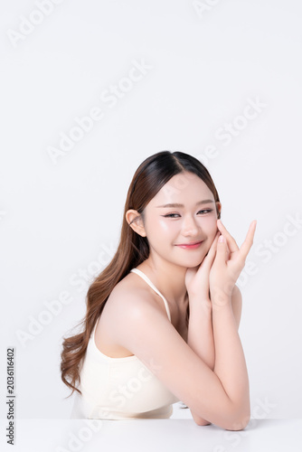 Beautiful young Asian woman clean healthy skin with hand touching face so gentle on white background. for advertising about skincare, cosmetics, beauty makeup concepts.