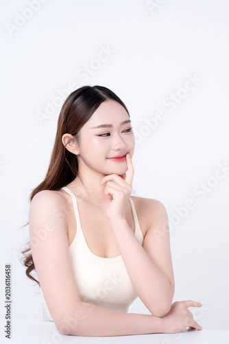 Beautiful young Asian woman clean healthy skin with finger touching mouth on white background. for advertising about cosmetics, beauty makeup concepts.