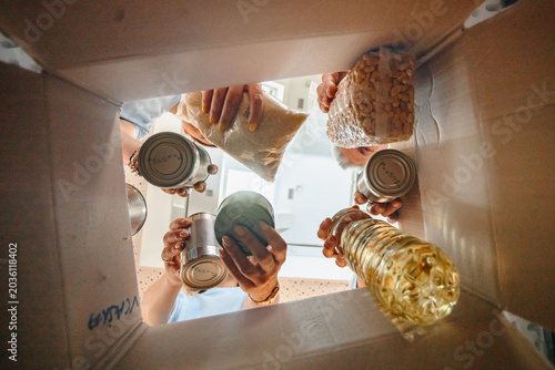 Bild auf Leinwand People donating groceries to food bank charity box