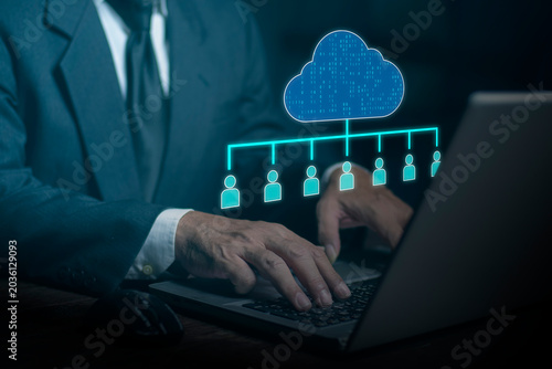 Businessman using computer laptop cloud computing with interconnected people network