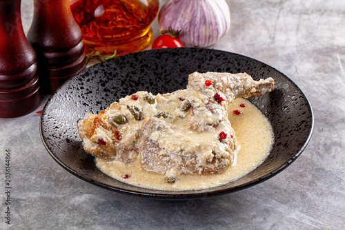 Foto Roasted rabbit legs in cream sauce