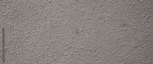 Fotografia Gray bumpy plaster wall suitable for background or texture in design projects