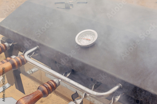 Fotografija shish kebab shashlik on the barbecue skewers. Cooking process