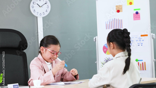 Photos Young Asian Girl in Pink Blazer Roleplaying Business Meeting in Office