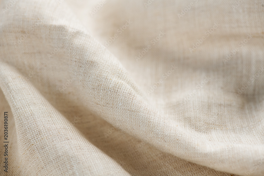 Fototapeta premium Linen fabric texture, natural eco folded linen background. Bio textile material backdrop, canvas top view, close up 