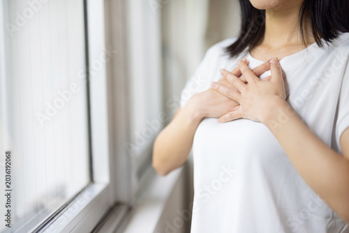 Tableau sur toile Close-up of woman's hand placed on chest