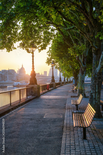 Canvas Print Calm view of the Southbank in London, England, with view of the City skyline dur