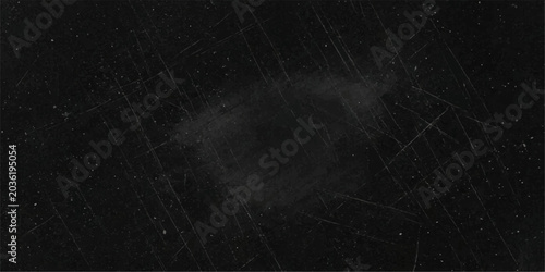 Photos A dark, scratched surface suggests a story of time and wear, inviting imagination and intrigue