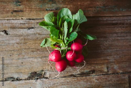 Bunch of red radishes on wood