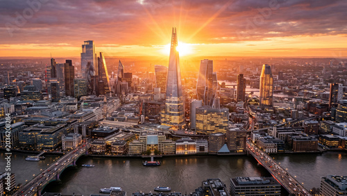 Dramatic Drone View of Contemporary Metropolitan Skyline at Golden Hour, Luxury Urban Architecture and Corporate Business Background