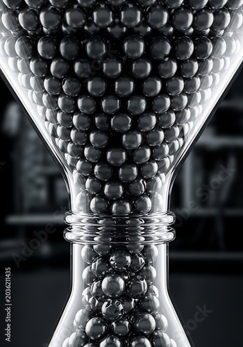 Metallic sphere hourglass, black and white close-up, industrial still life, glass funnel