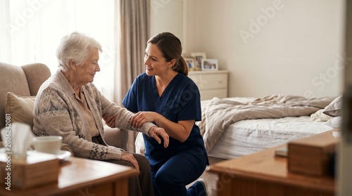 Nurse assisting elderly woman in her home