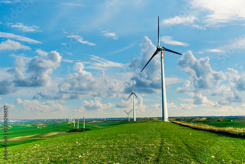 Принти на полотні wind power plant concept of wind turbine close up and blue sky on background