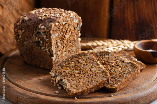 Rye bread with sunflower seeds on wooden cutting board, rustic style bread