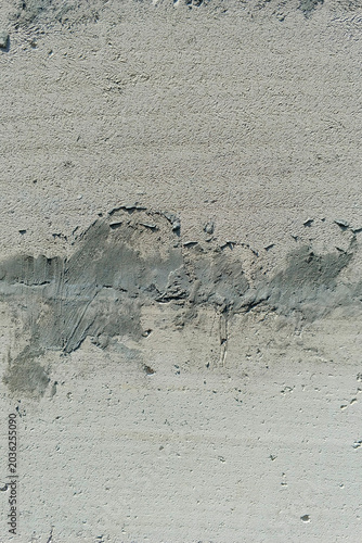 Cuadro en lienzo Close-up rough stucco surface with dark grey cement patching and visible flaws