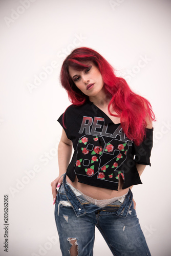 Woman with red hair posing on a white background