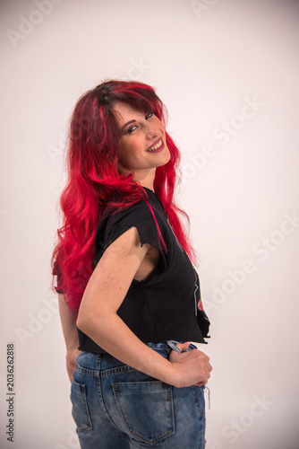 Confident young woman with bright red hair smiling