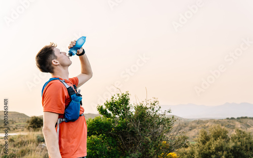 Man hydrating during trail running outdoor activity