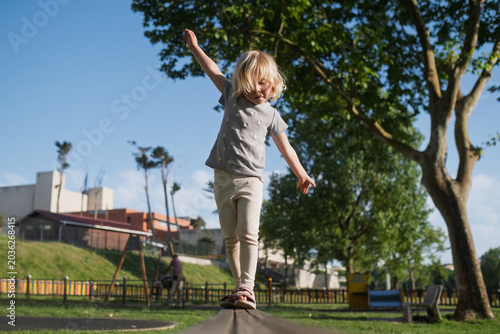Active kid practicing balance and coordination on a sunny day.