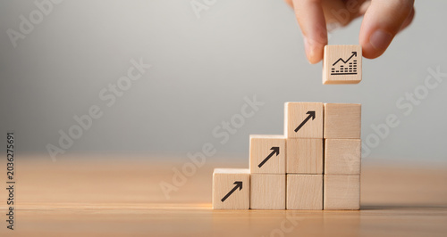 Vászonkép Sale volume increase make business grow , Business growth concept , wood block stacking as step stair on paper blue background, copy space