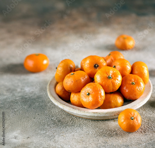 Принти на полотні fresh organic tangerines in a bowl on the table