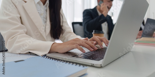 Canvas-taulu Business person typing on laptop in modern office