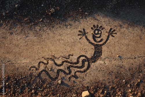 Ancient Cave Drawing of a Smiling Snake and Human Figure
