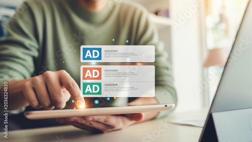 Person using tablet for digital marketing and online advertising with virtual ad banners on screen.