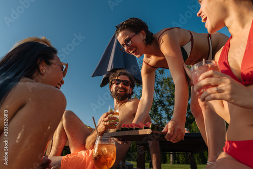 Obraz na płótnie Friends enjoying summer party with watermelon and drinks