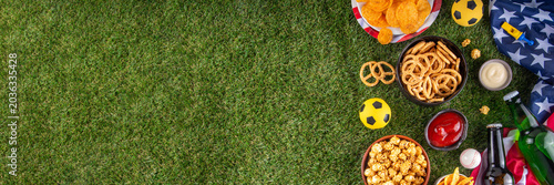 International football soccer championship background, soccer matches cheering concept with beer bottles, party snacks chips, popcorn, pretzel, nuts, whistle and soccer ball, american flag, copy space