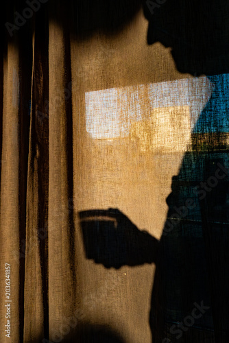 Photography Stockholm, Sweden A man stands in the morning shadow with a coffee pot in his hands in a residential kitchen