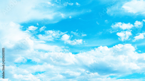 Bild auf Leinwand A bright blue sky with fluffy white clouds on a sunny day outdoors
