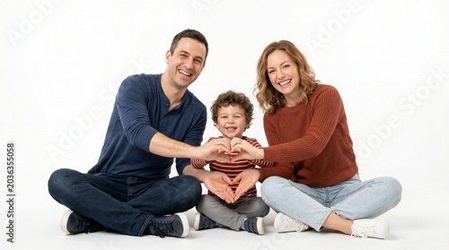 Happy Family Moment: A loving family, composed of parents and their young child, creates a heart shape with their hands, symbolizing unity and affection. They are seated together.