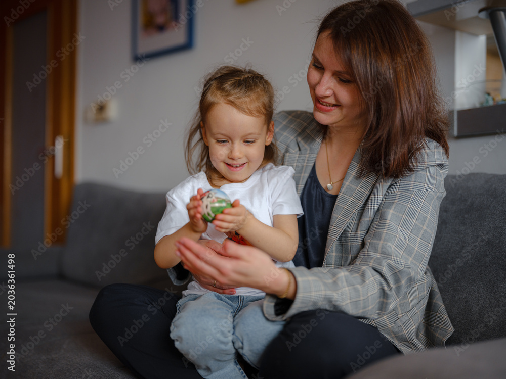 Φωτογραφία Mom, girl and hug with portrait on sofa for bonding with love, affection and childhood security for support