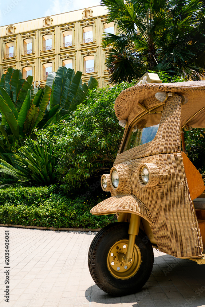 Obraz premium Unique wicker tuk-tuk awaits visitors outside the elegant Boutique Dior Gold House on Phloen Chit Road Lumphini Bangkok Thailand on April 27 2026