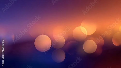 Soft bokeh light orbs glowing on vibrant gradient sunset background with smooth blur