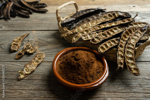 Tableau sur toile Organic Carob Pods on Rustic Background