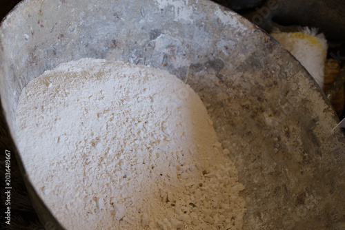 White powder in rustic metal container close-up