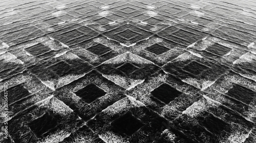 Abstract black and white symmetrical water waves forming a grid pattern