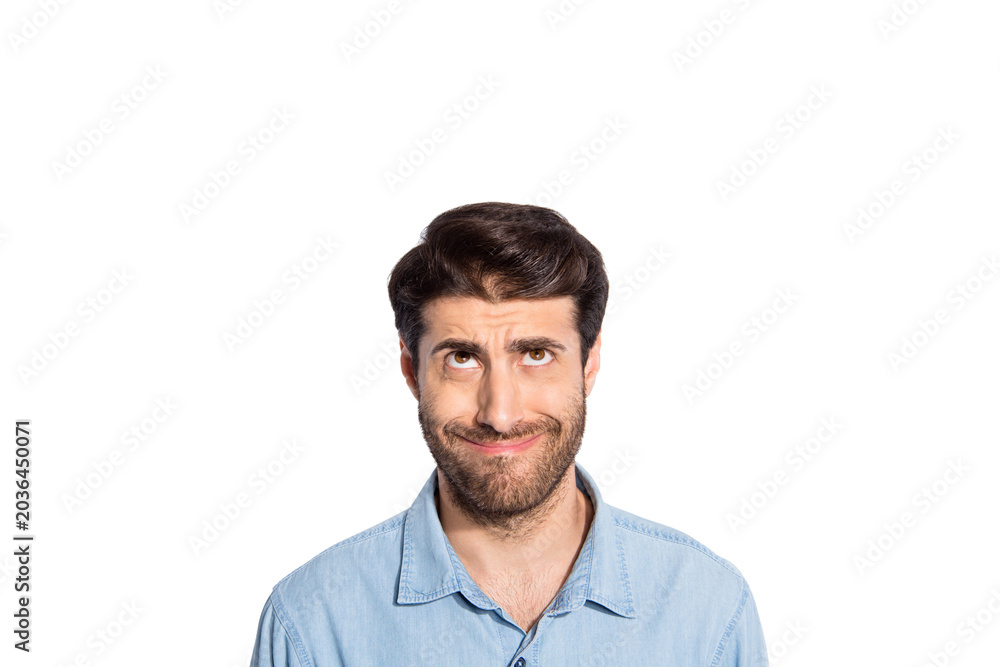 Obraz premium Photo of amazing mixed race guy looking up empty space making fake smile seeing terrible high shopping prices wear casual denim shirt isolated white color background