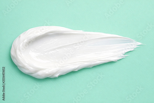 A substantial amount of a thick, off-white mashed substance on a vibrant green background