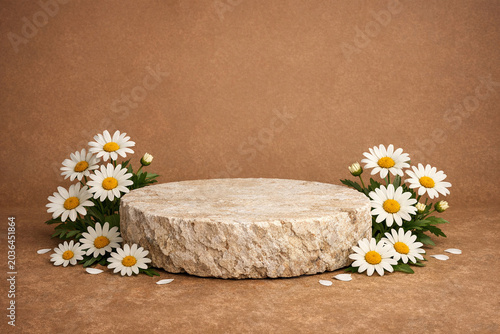 A close-up photograph of a round stone resting on a brown surface adorned with white flowers and pebbles.