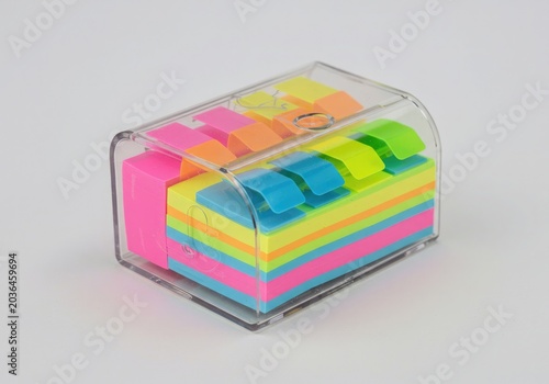 Colorful Sticky Note Flags in Clear Plastic Dispenser Box on White Background for Office Organization