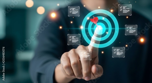 Businessman's finger touching a glowing target with dart in the center, representing business goals and success