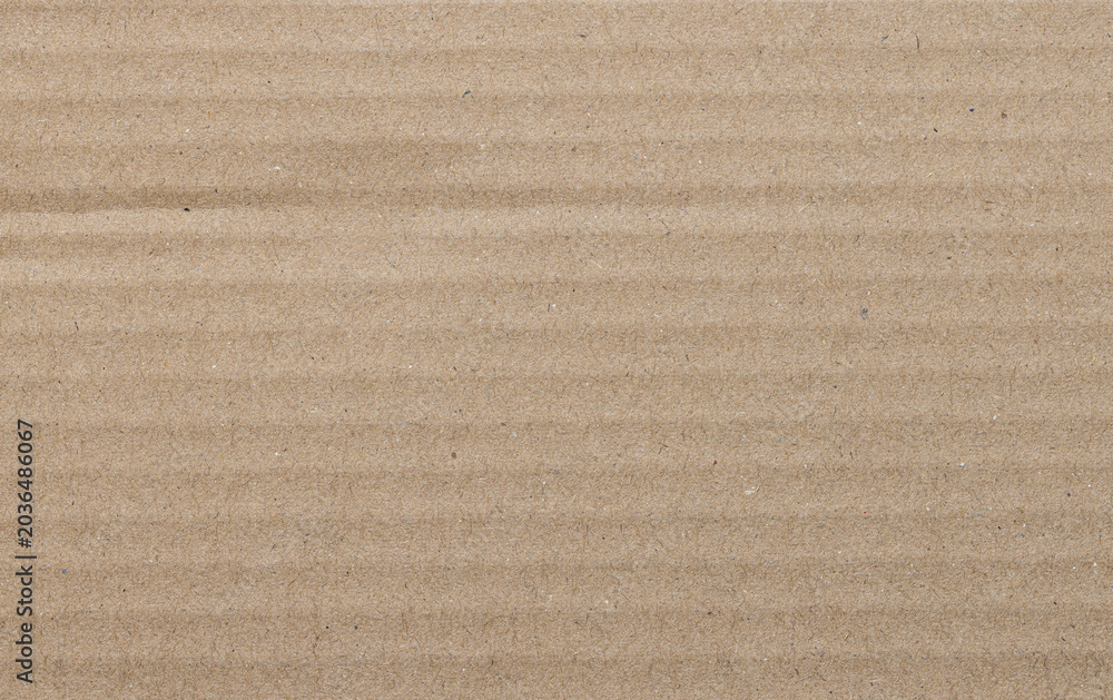 Fototapeta premium Brown Corrugated Cardboard Texture Background,Macro,Close-up full frame shot of a light brown corrugated cardboard sheet, highlighting the natural paper fiber texture and parallel embossed ridges.