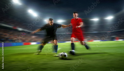 Canvas-taulu Soccer players battling for ball with motion blur in fast night game